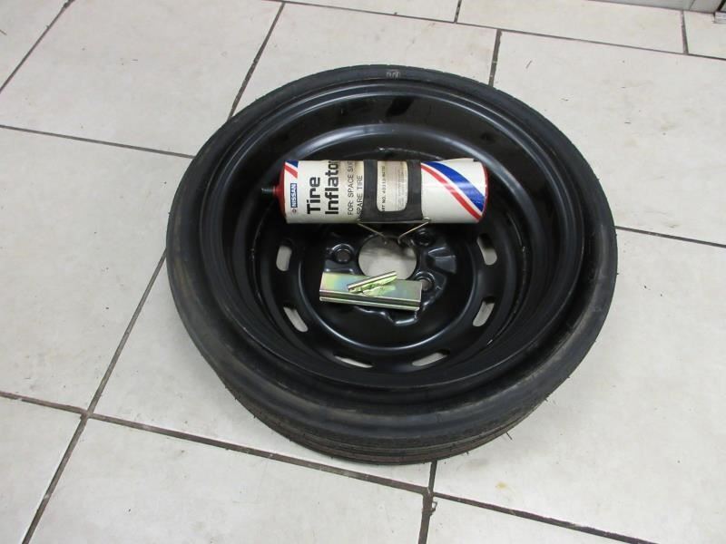 84-89 Nissan 300ZX UNUSED spare tire w/inflator and tie Down 